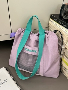 Purple nylon tote bag with green handles and mesh pocket for casual or campus use