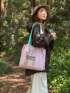 Minimalist lavender nylon tote bag with drawstring closure and mint green strap for daily use