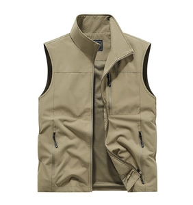 Detail of khaki outdoor vest showing zip pockets and breathable mesh lining