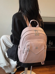 Pink lychee texture backpack for women with silver hardware and front flap pocket