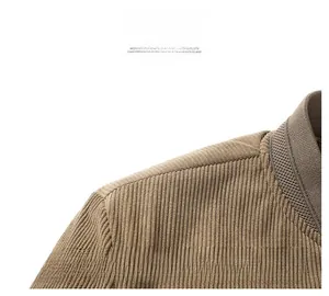 Detailed macro view of khaki corduroy fabric texture and shoulder seam on a vintage jacket