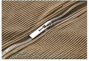 Macro shot of durable silver metal zipper on vintage brown corduroy jacket fabric