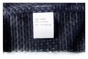 Detail view of breathable mesh lining and 100% nylon material label for fishing vest