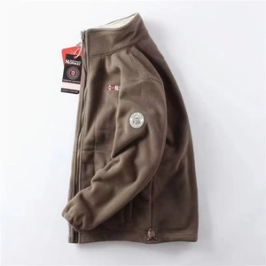 Close-up of brown fleece jacket with nautical sleeve badge and Norway branding tag