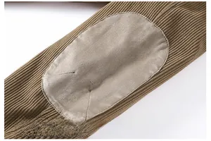 Detail of khaki corduroy jacket sleeve featuring durable oval faux suede elbow patches
