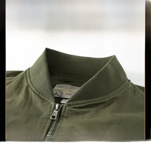 Close-up detail of the ribbed collar and metal zipper on this army green cotton jacket