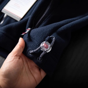 Dark blue thermal polar fleece jacket with adjustable toggle and metal zipper detail