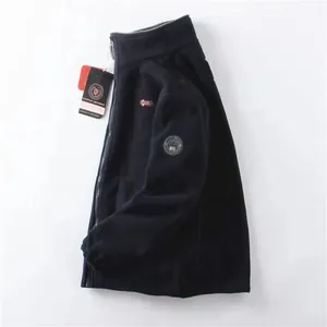 Detail of navy blue fleece jacket with high collar and Norway embroidered chest patch