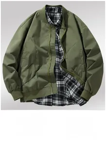 Close-up of olive green bomber jacket featuring rib-knit collar and premium fabric texture