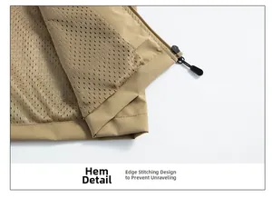 Close-up of khaki fishing vest hem featuring mesh lining and durable locked edge stitching