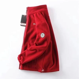 Detail of red fleece jacket featuring high collar and Norway embroidered badge