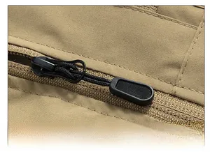 Detailed macro view of the premium smooth zipper and durable khaki outdoor fabric texture