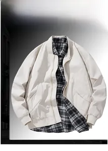 Detail of light beige windbreaker jacket featuring a zipper pocket and a checkered shirt collar