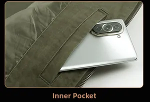 Detail shot of the functional inner pocket on a green cotton jacket with a smartphone inside
