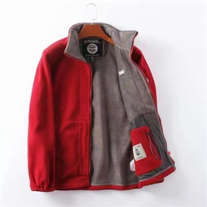 Detail view of red fleece jacket featuring interior zipper pocket and gray fleece lining