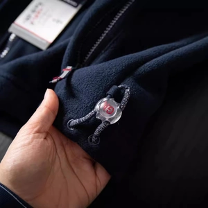 Navy polar fleece jacket featuring adjustable drawstring with branded toggle detail