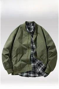 Detailed flat lay of an army green bomber jacket with a classic black and white plaid shirt