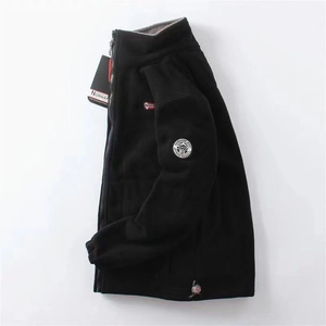 Detail view of Norway embroidery patch and warm fleece lining on black zip-up jacket