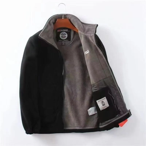 Macro detail of the grey double-sided polar fleece lining on this warm black winter jacket