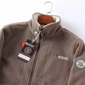 Detail of taupe double-sided fleece jacket with Norway embroidery and stand collar