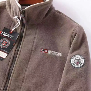 Detail of warm brown fleece jacket with white lining and Norway embroidery
