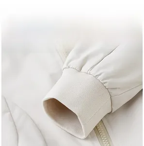 Detailed macro view of the elastic ribbed cuffs on a beige hooded sports jacket