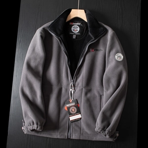 Close-up of grey fleece outdoor jacket featuring embroidered logo and stand collar
