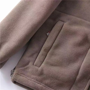 Detailed macro view of the warm fleece fabric texture and adjustable toggle drawstring hem