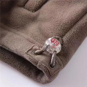 Macro detail of dark brown fleece jacket with drawstring hem and GN toggle fastener