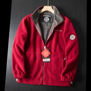 Close-up of red fleece outdoor jacket with full zip and Geographical Norway brand logo
