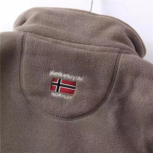 Detail of the high-collar fleece jacket with Norway flag and brand name embroidery
