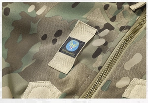 Detail of camouflage tactical jacket showing Special Forces patch and metal zipper