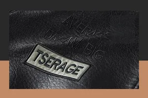 Close-up of black lychee grain faux leather jacket with Average Dream Big embroidery detail