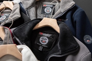 Detail of stacked polar fleece jackets with Norway embroidery and stand collar
