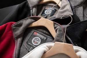 Close-up of a warm fleece jacket collar featuring a protective zipper and embroidery