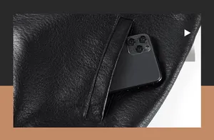 Detail shot of the side slant pocket on a black pebble leather jacket with a smartphone