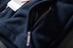 Macro shot of durable zipper pocket and fleece texture on outdoor winter jacket