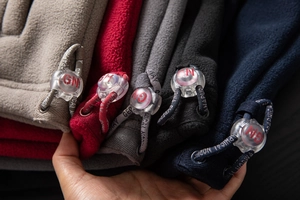 Detail of soft fleece fabric texture with Geographical Norway branded drawstring adjusters