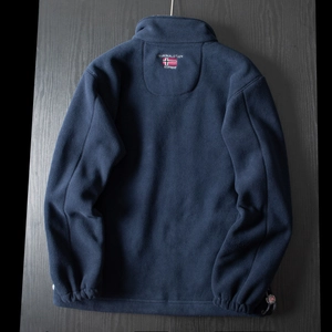 Detail of navy fleece jacket back featuring Norway flag embroidery and regional text