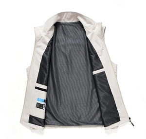 Detail view of breathable black mesh lining and inner pocket on beige outdoor vest