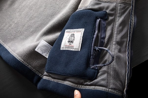 Detail of warm fleece lining with secure zippered pocket and breathable mesh fabric