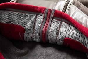 Detailed view of thermal fleece jacket lining with mesh fabric and red resin zipper