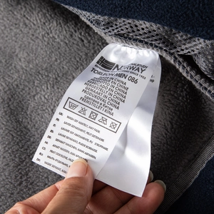 Detailed view of inner fleece lining and washing instructions label on outdoor jacket