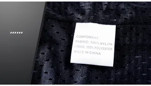 Detail view of the wash label showing 100% nylon fabric on a black mesh vest