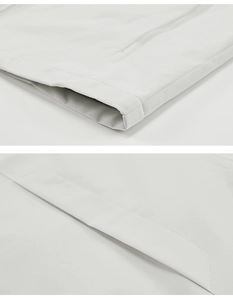 Detailed macro view of the double stitching and waterproof seam sealing on the grey vest