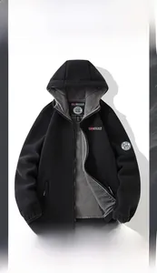 Detail showing the gray polar fleece lining and sturdy zipper of the black hooded jacket