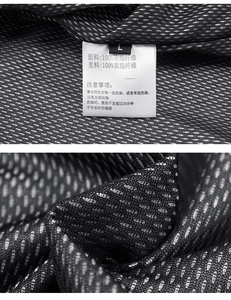 Detail of 100% polyester honeycomb breathable mesh fabric and washing label on men's vest