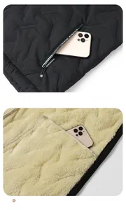 Detail view of the quilted vest pocket with logo zipper and thick warm fleece lining