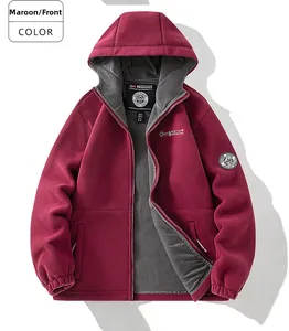 Close-up of burgundy fleece hoodie featuring grey inner lining and brand chest badge