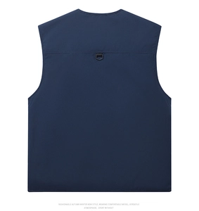Detail view of the back of a navy blue fishing vest featuring a D-ring and durable fabric